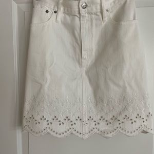White denim skirt with and eyelet trim. 18” long to bottom tim of scallop edge.